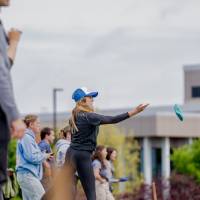 A participant throws a bag while other plays look on